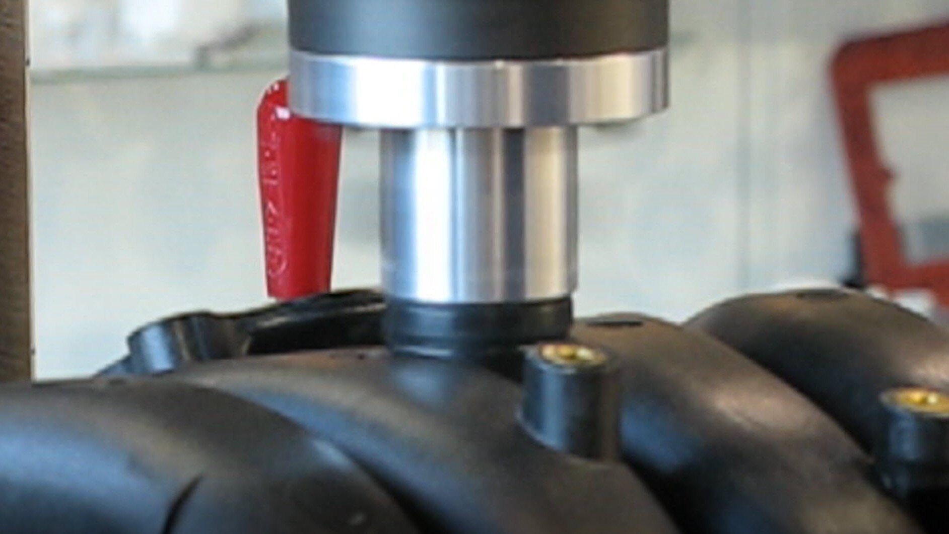 Close up of port being spin welded to engine manifold Close up of port being spin welded to engine manifold